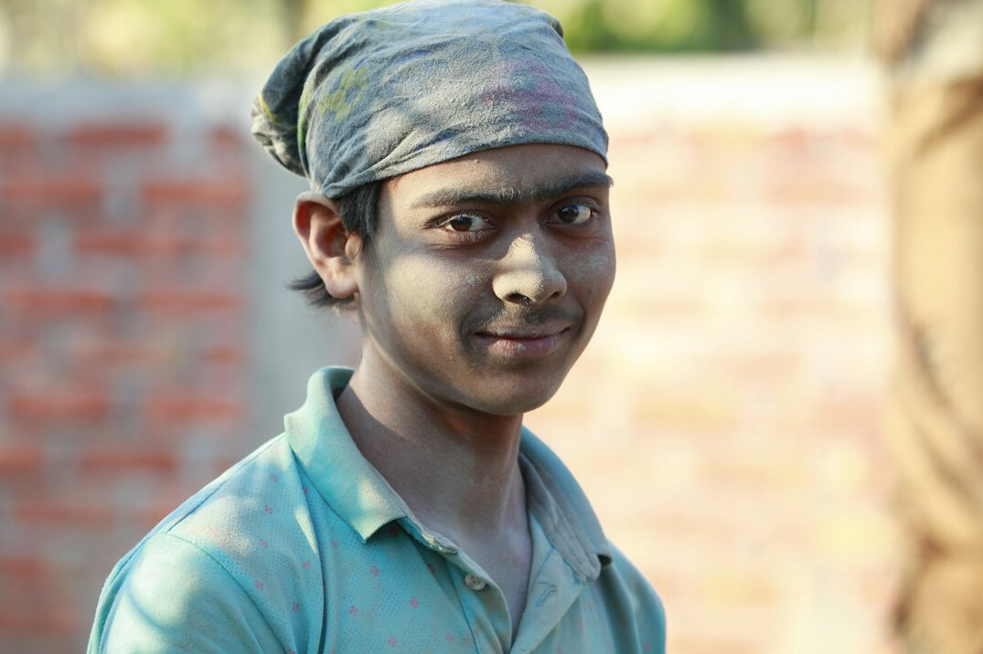 Portrait of a young man in a shirt smiling
