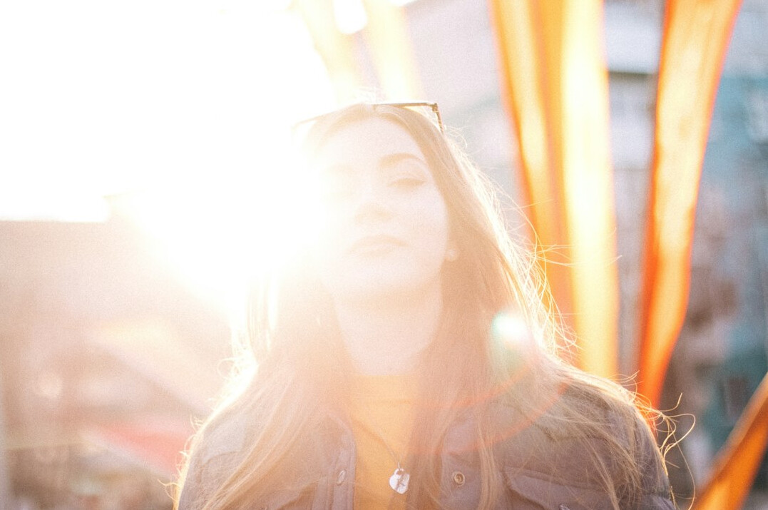 Portrait of a smiling woman with long hair in a bright setting